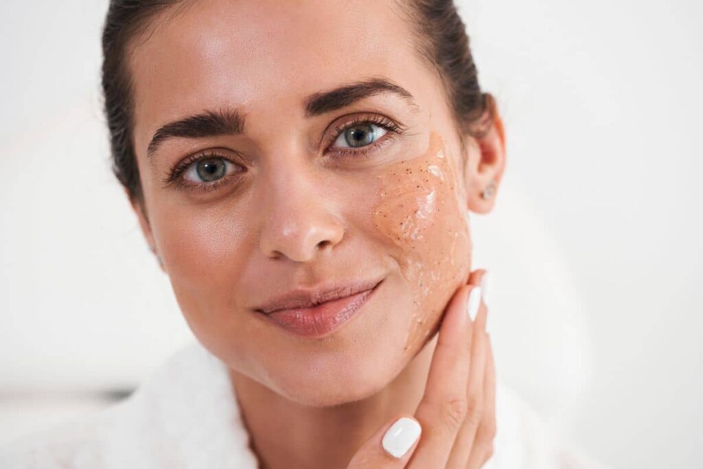 Woman applying gentle glycolic acid peel to exfoliate skin and improve texture at home.