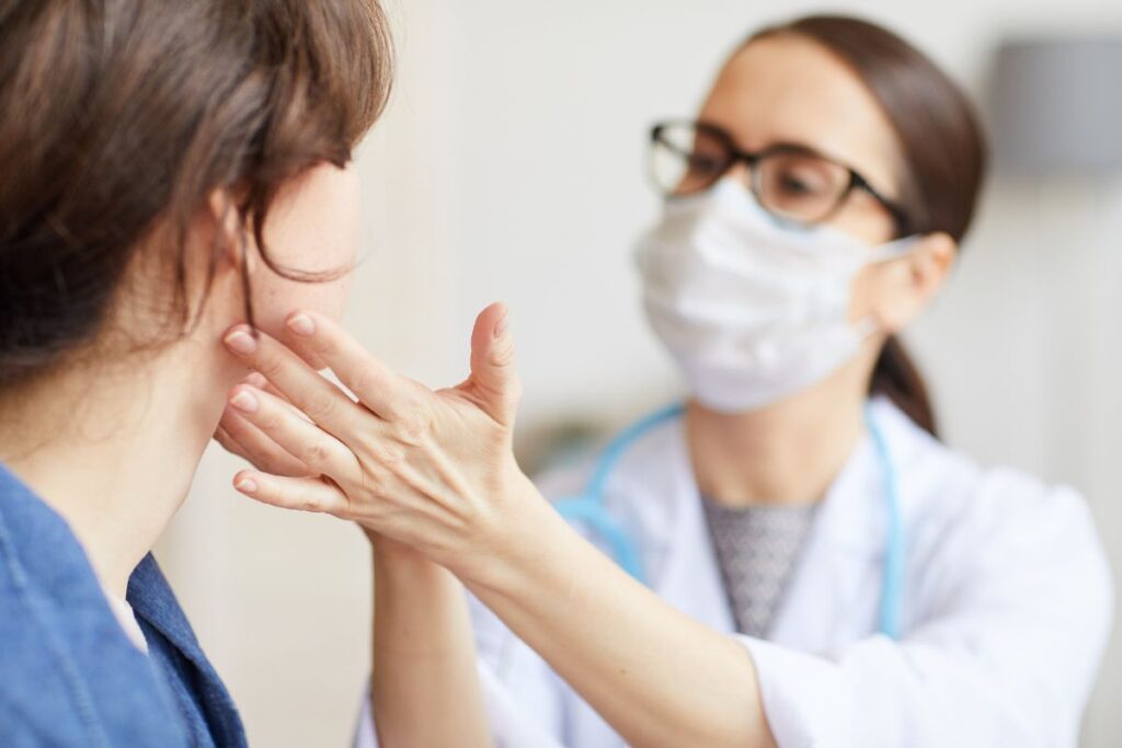 Facial plastic surgeon examining patient's facelift scar for potential scar revision surgery consultation.
Ask ChatGPT