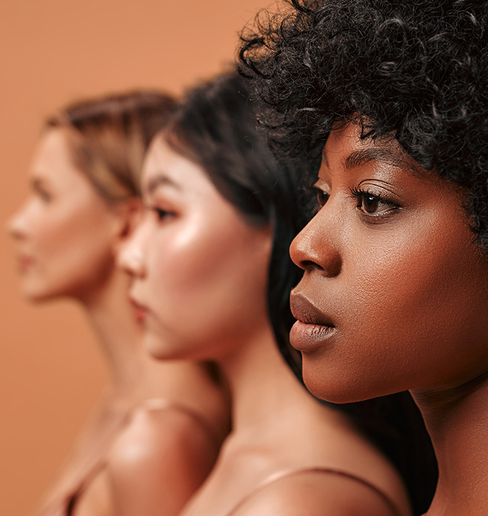 Diverse women with distinct nasal profiles representing tailored ethnic rhinoplasty techniques respecting facial identity