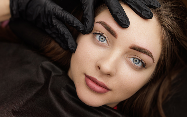 Woman with smooth skin after Botox, symbolizing gradual results and ongoing care through personalized follow-up visits
