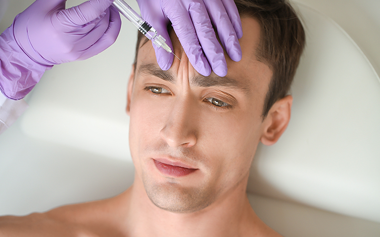 Man receiving Botox injection for frown lines in Hillsborough, NJ, highlighting personalized treatment for male patients