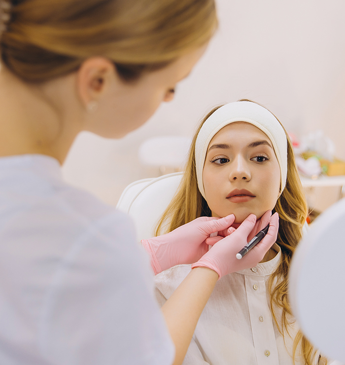 Young woman receiving personalized Botox consultation in Yardley, PA, with provider assessing facial structure and treatment plan
