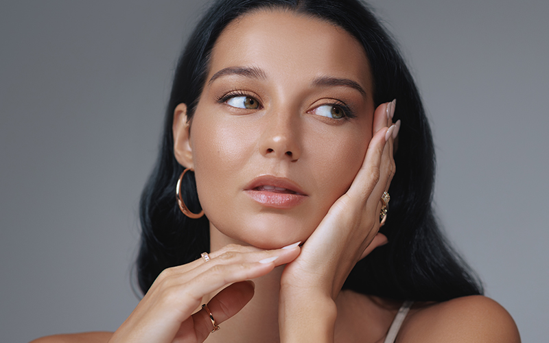 Woman with refined nose and balanced features symbolizing goals of cosmetic rhinoplasty for facial harmony.
