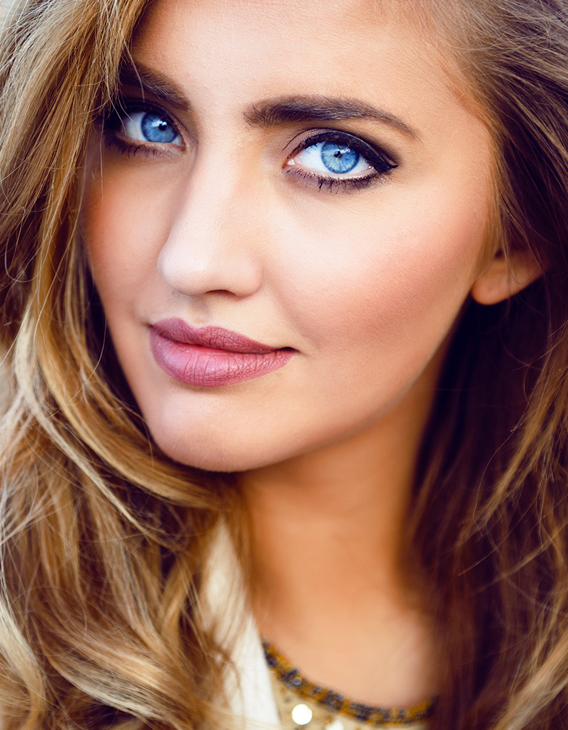 Close-up of woman with defined eyelids illustrating blepharoplasty results and potential surgical risks discussed in recovery section.