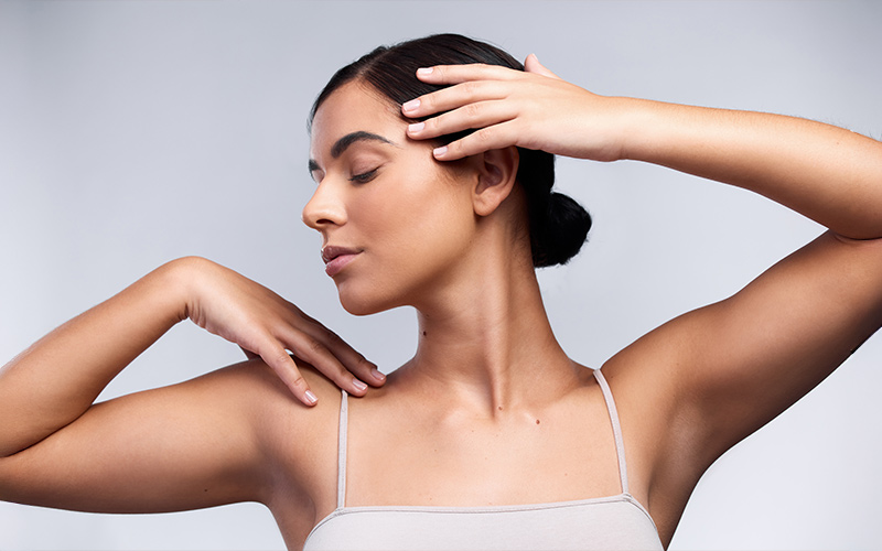 Woman demonstrating toned upper arms illustrating brachioplasty arm lift results and improved contour definition.