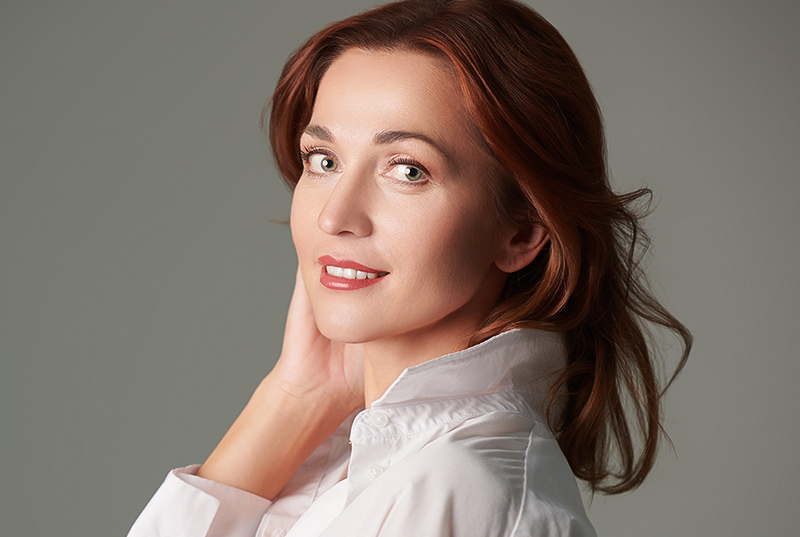 Confident woman with lifted brows and smooth forehead highlighting brow lift results in New Jersey and Philadelphia.