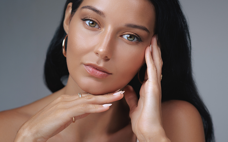 Woman with smooth skin and refined facial contours after cheek and face liposuction, showcasing a slimmer, youthful profile.