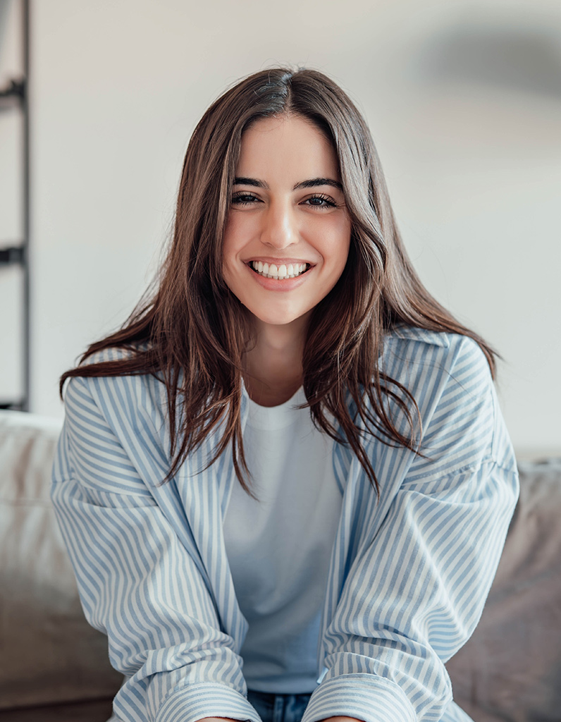 Smiling woman with smooth skin, representing dermal filler benefits for facial rejuvenation and natural-looking results