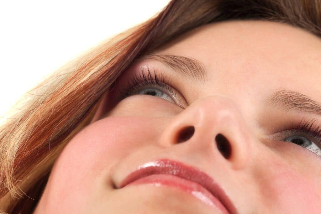Close-up view of nostrils illustrating deviated septum and nasal obstruction treated with functional rhinoplasty