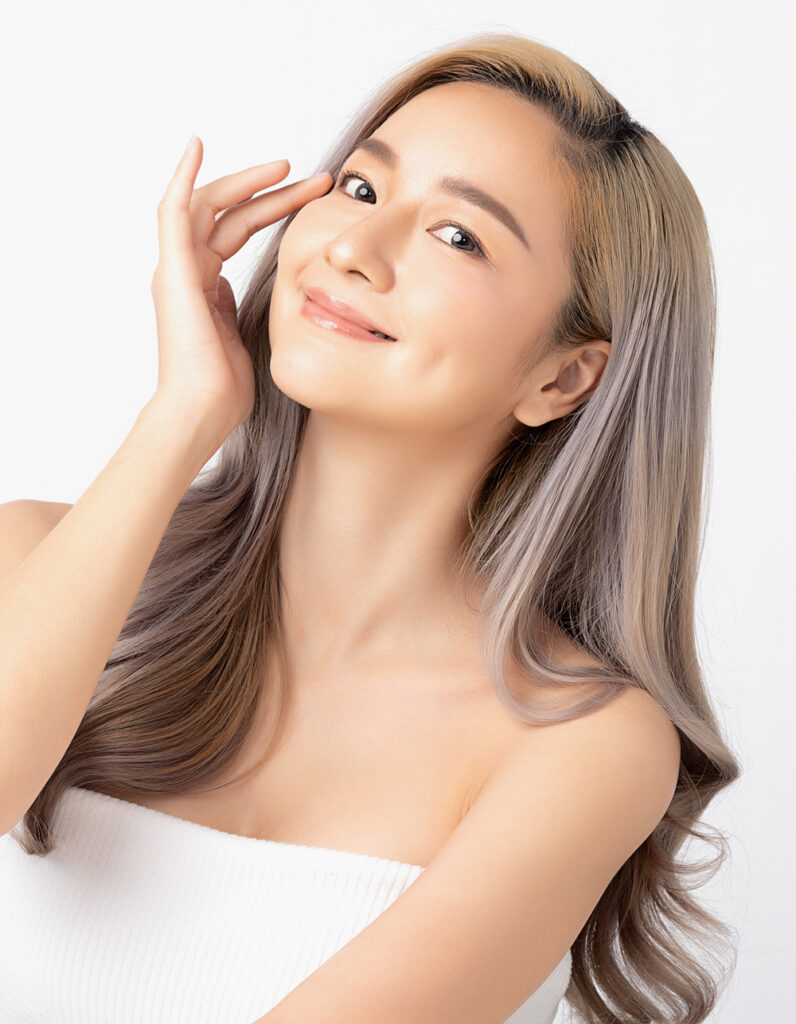 Smiling woman with refined nasal features representing ethnic rhinoplasty differences from traditional nose surgery techniques