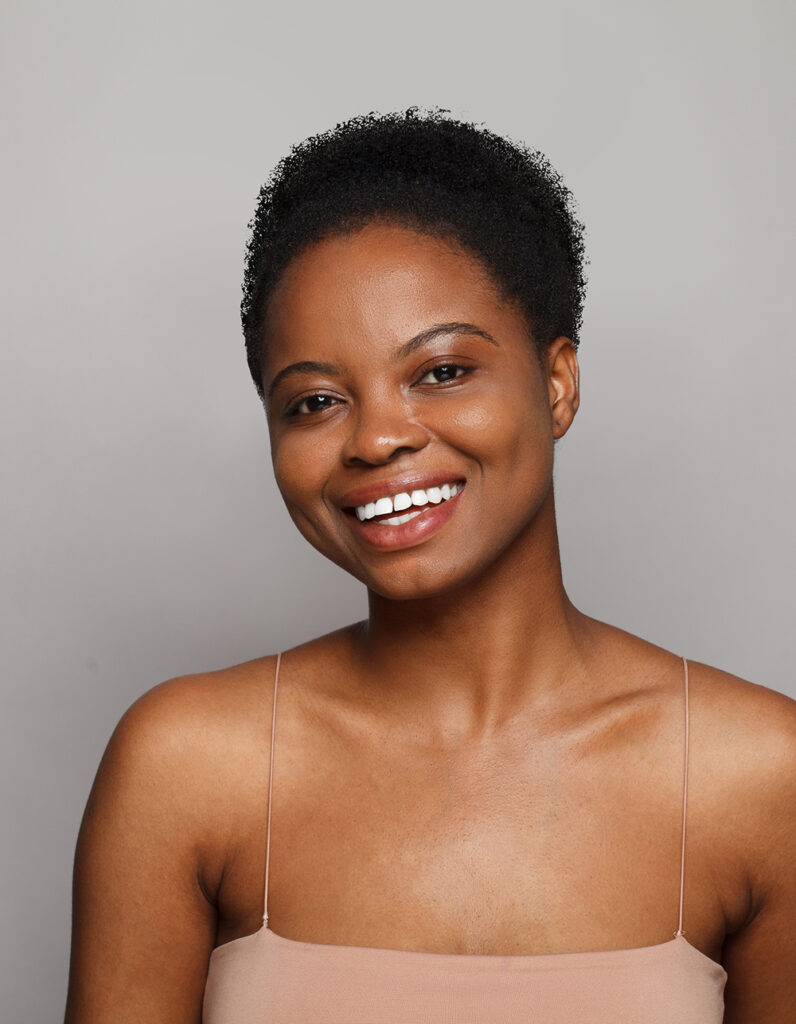 Smiling woman representing natural results in ethnic rhinoplasty