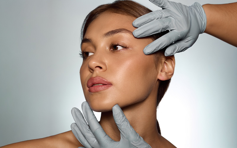 Provider assessing facial proportions during facial balancing consultation in Philadelphia