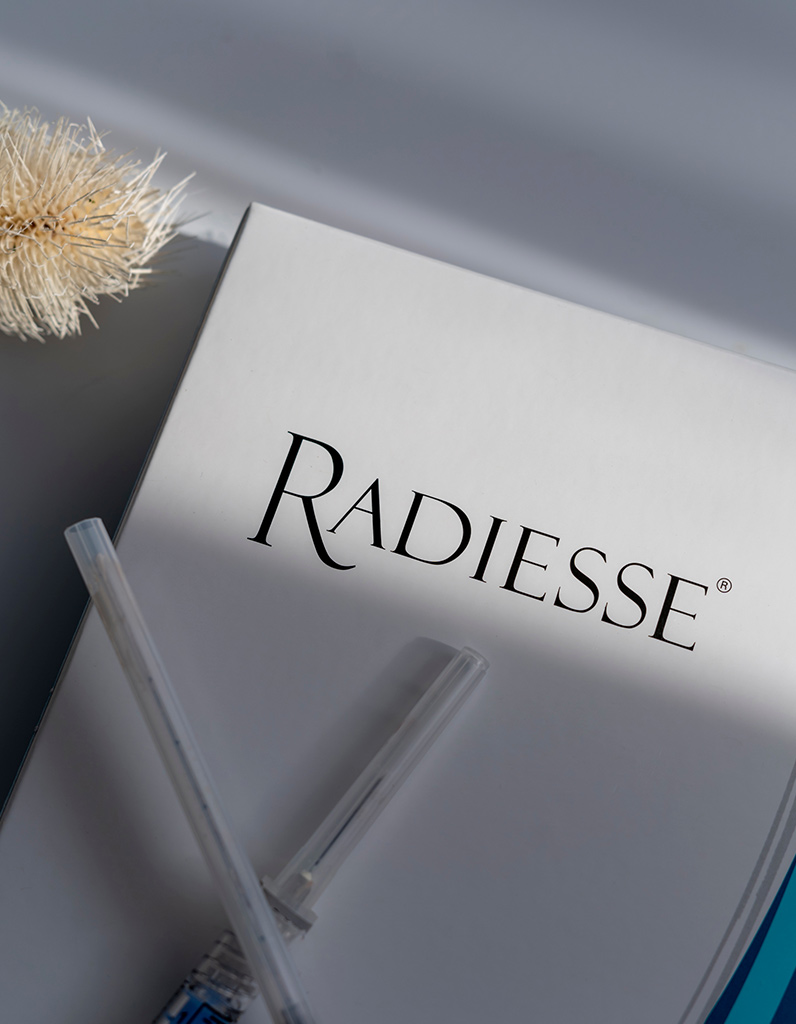 Radiesse product packaging representing dermal filler treatment and safety information.
