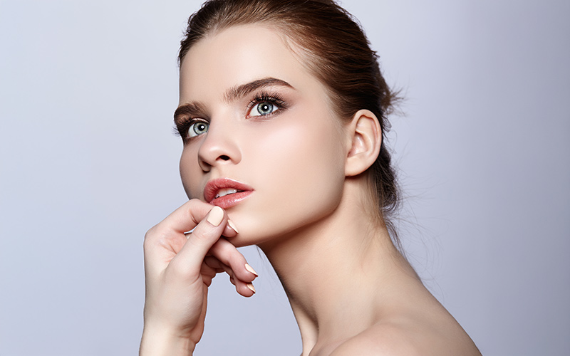 Woman representing rhinoplasty for crooked nose correction in Philadelphia.