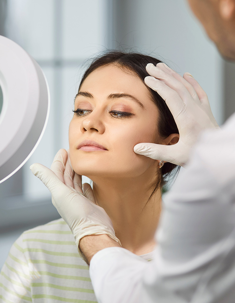 Doctor assessing patient’s face after Silhouette InstaLift treatment.