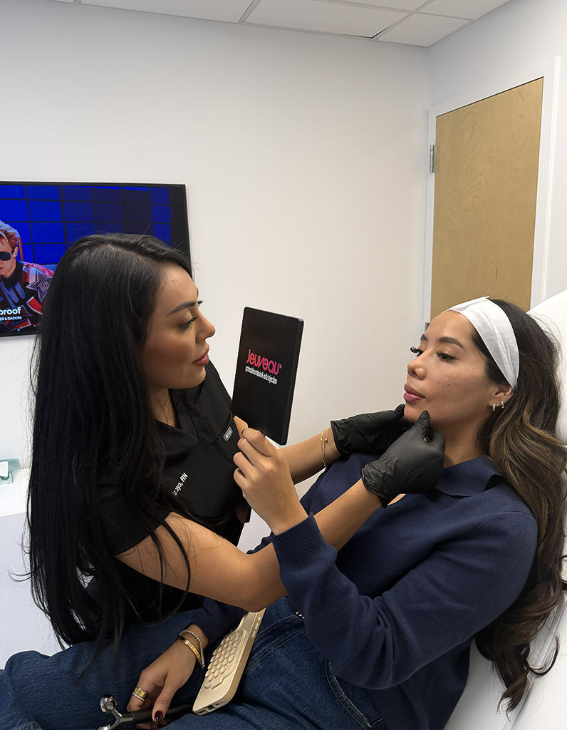 Aesthetic provider evaluating patient’s facial proportions during facial balancing consultation in clinic.