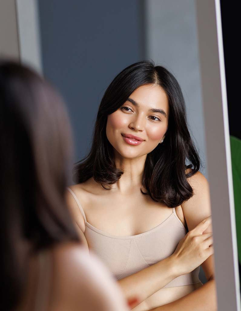 Woman reviewing nasal profile before rhinoplasty consultation