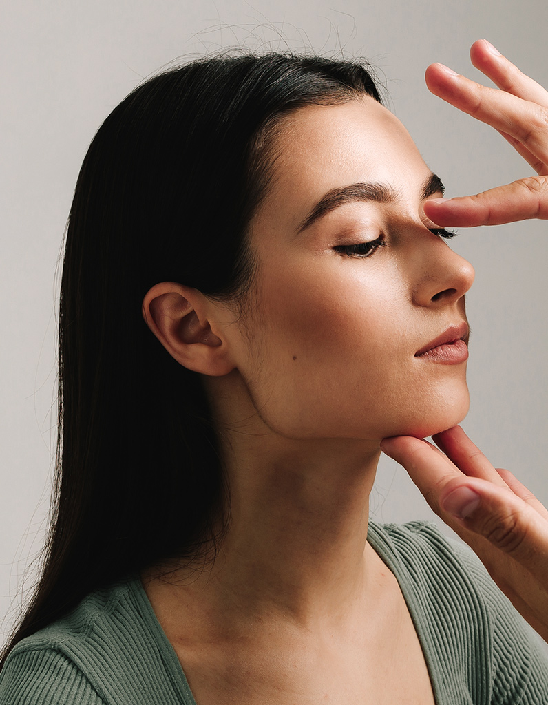 Side profile of woman during nasal evaluation demonstrating nasal tip projection assessment for rhinoplasty in Philadelphia.