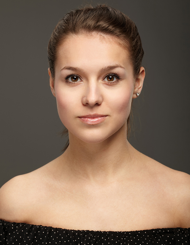 Frontal facial view of woman with balanced nasal bridge representing reconstructive rhinoplasty for saddle nose.