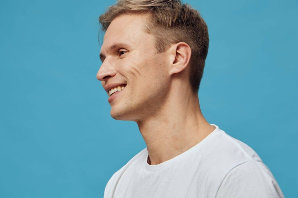 Man showing refined side profile after non-surgical rhinoplasty treatment with natural-looking facial balance.