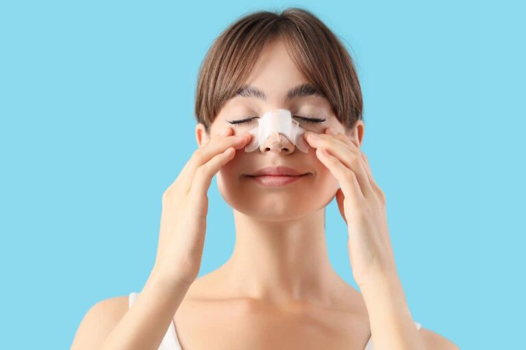 Woman with nasal bandage after rhinoplasty illustrating recovery and scarring differences in open vs closed techniques