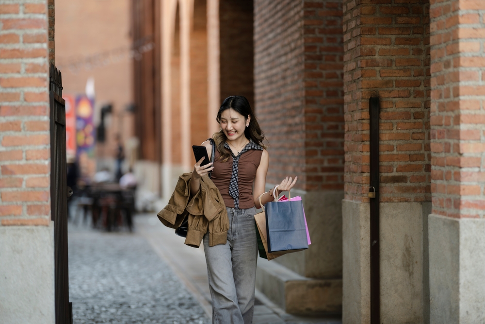 Woman walking with shopping bags during weeks three and four of labiaplasty functional recovery.